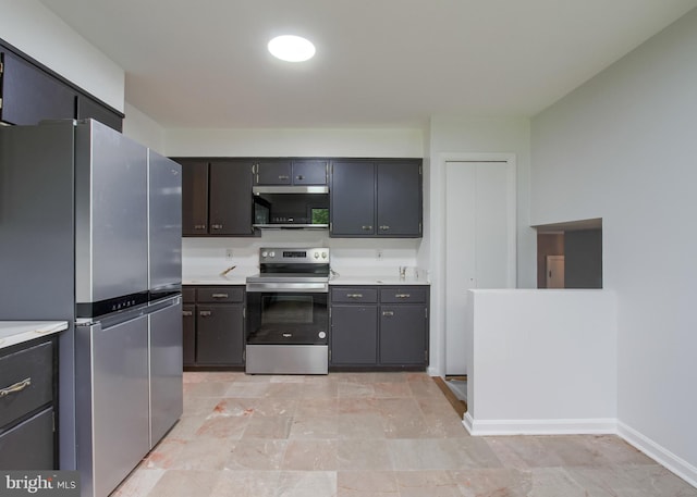 3900 Mark Ave, Harrisburg, PA 17110 - kitchen featuring stainless steel appliances, light countertops, and baseboards
