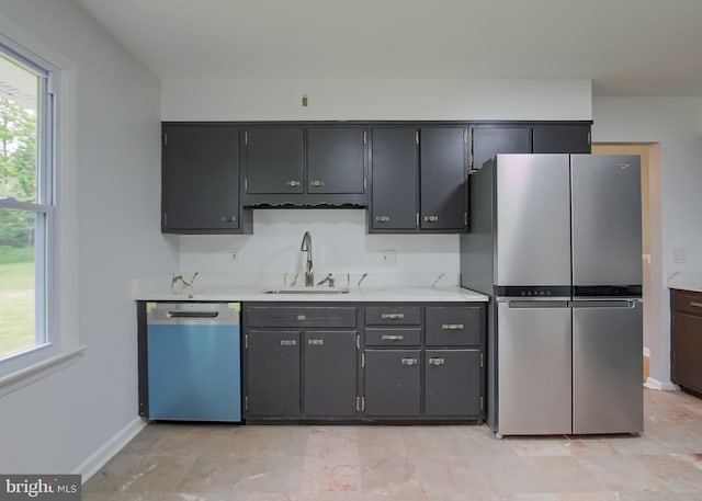 3900 Mark Ave, Harrisburg, PA 17110 - kitchen featuring dishwashing machine, freestanding refrigerator, a sink, light countertops, and baseboards