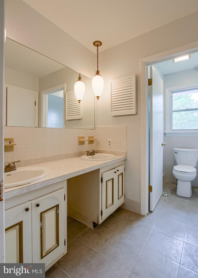 3900 Mark Ave, Harrisburg, PA 17110 - bathroom with double vanity, decorative backsplash, tile patterned flooring, and toilet
