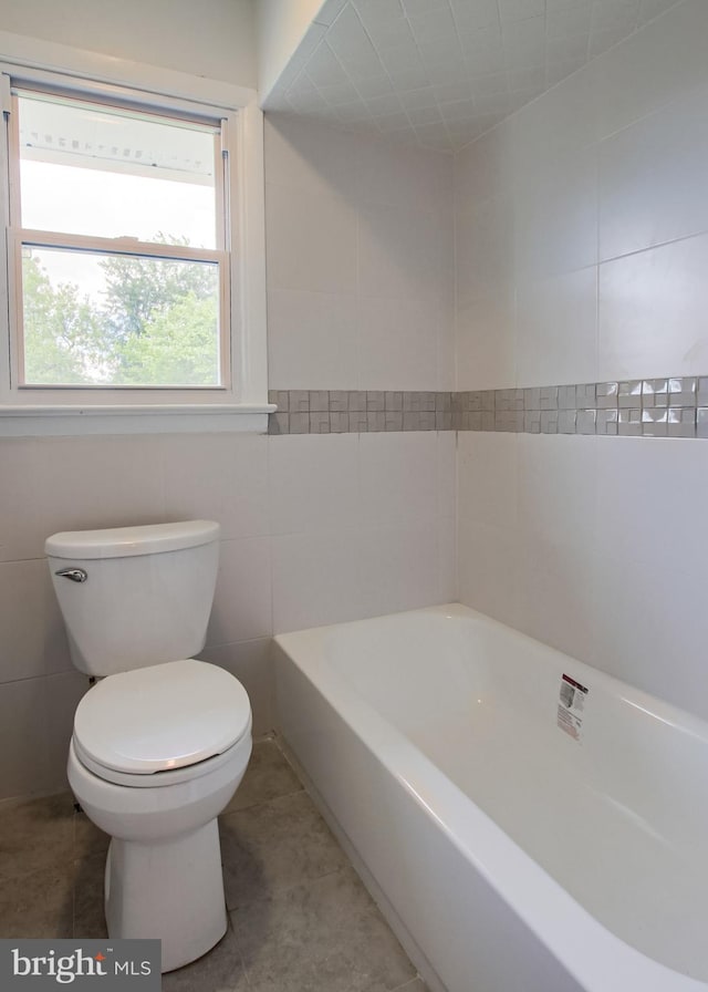 3900 Mark Ave, Harrisburg, PA 17110 - full bath featuring toilet, a tub to relax in, tile walls, and tile patterned flooring