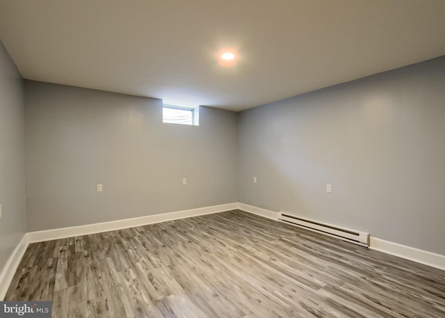 3900 Mark Ave, Harrisburg, PA 17110 - below grade area featuring a baseboard heating unit, wood finished floors, and baseboards