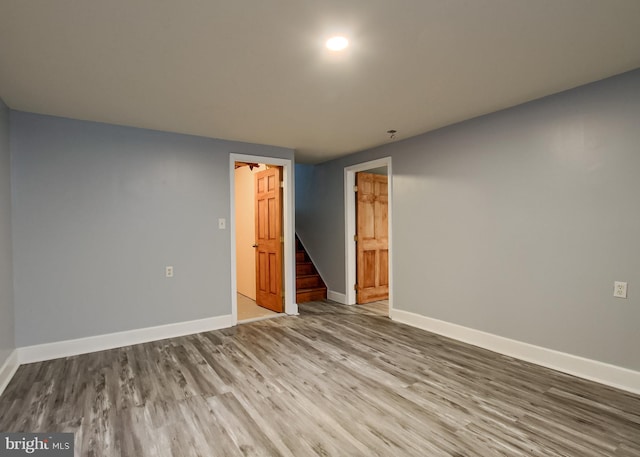 3900 Mark Ave, Harrisburg, PA 17110 - spare room with baseboards, wood finished floors, and stairway