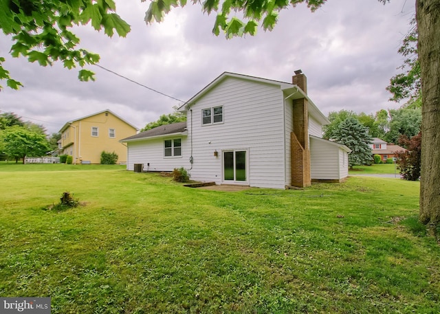 3900 Mark Ave, Harrisburg, PA 17110 - rear view of house with a chimney and a yard