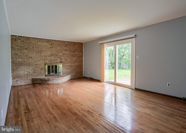 3900 Mark Ave, Harrisburg, PA 17110 - unfurnished living room with wood finished floors, a fireplace, and baseboards