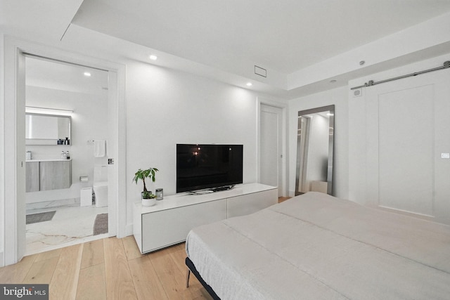 1111 19th St N Unit 2108, Arlington, VA 22209 - bedroom with recessed lighting, light wood-style floors, and ensuite bathroom