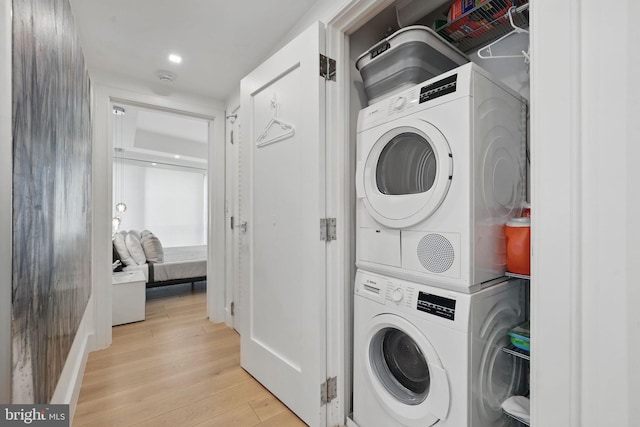 1111 19th St N Unit 2108, Arlington, VA 22209 - washroom with stacked washer and clothes dryer and light wood-style floors