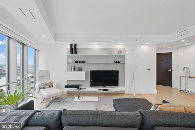 1111 19th St N Unit 2108, Arlington, VA 22209 - living area featuring wood finished floors, recessed lighting, and a raised ceiling