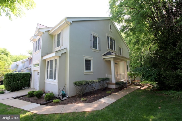 1300 Park Garden Ln, Reston, VA 20194 - view of front of property featuring stucco siding and an attached garage