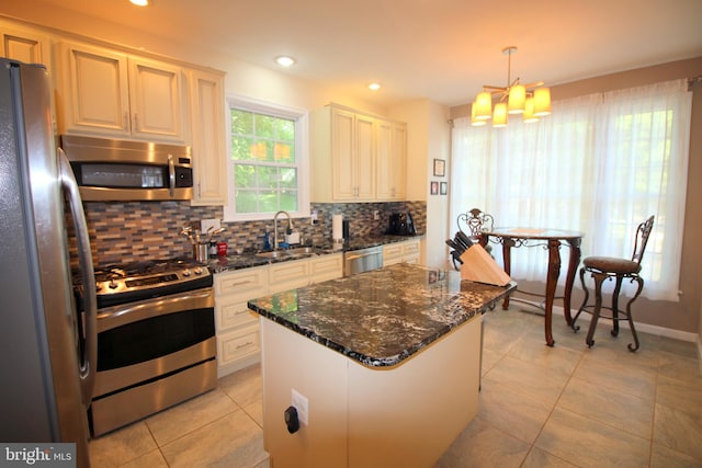 1300 Park Garden Ln, Reston, VA 20194 - kitchen featuring appliances with stainless steel finishes, a sink, tasteful backsplash, light tile patterned flooring, and a center island