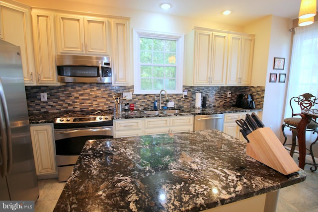 1300 Park Garden Ln, Reston, VA 20194 - kitchen featuring appliances with stainless steel finishes, a sink, healthy amount of natural light, dark stone counters, and recessed lighting