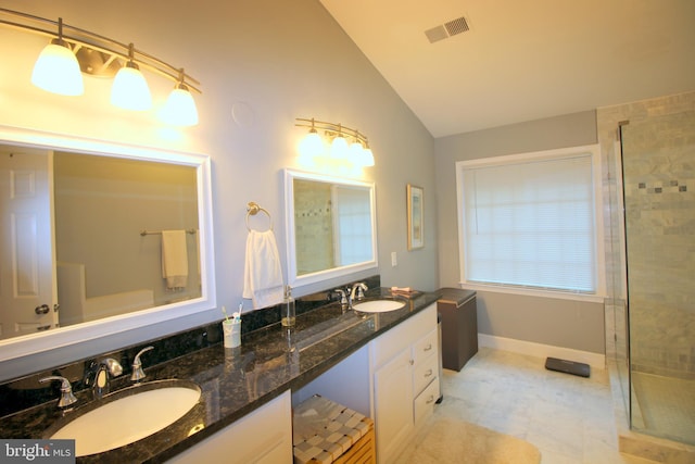1300 Park Garden Ln, Reston, VA 20194 - bathroom with lofted ceiling, tiled shower, double vanity, and baseboards