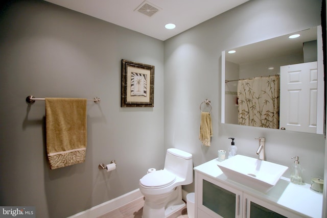 1300 Park Garden Ln, Reston, VA 20194 - full bathroom with toilet, baseboards, vanity, recessed lighting, and wood finished floors