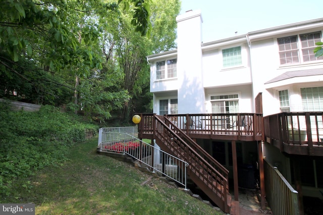 1300 Park Garden Ln, Reston, VA 20194 - back of property with a chimney, stairway, a deck, and stucco siding