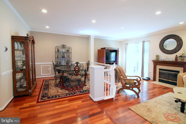1300 Park Garden Ln, Reston, VA 20194 - living room with crown molding, wood finished floors, a fireplace with flush hearth, and recessed lighting