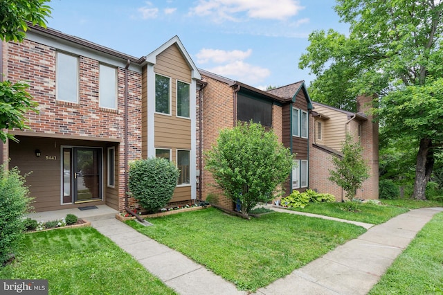 9441 Clocktower Ln, Columbia, MD 21046 - townhome / multi-family property featuring brick siding and a front yard