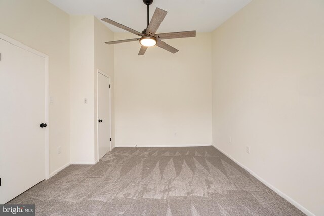 9441 Clocktower Ln, Columbia, MD 21046 - carpeted empty room featuring a ceiling fan, vaulted ceiling, and baseboards