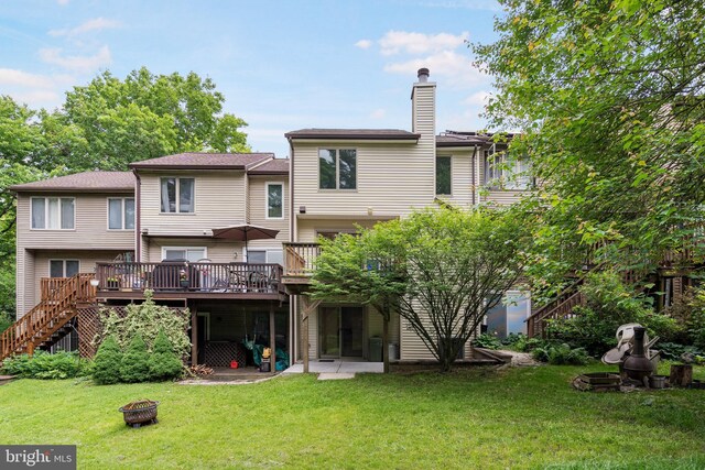 9441 Clocktower Ln, Columbia, MD 21046 - back of house featuring a fire pit, a deck, a chimney, a yard, and stairs