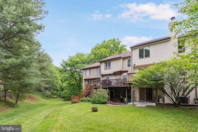 9441 Clocktower Ln, Columbia, MD 21046 - rear view of house with a deck, a lawn, and stairway