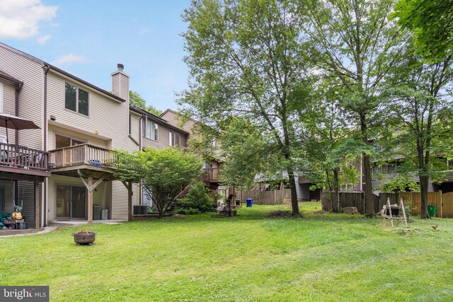9441 Clocktower Ln, Columbia, MD 21046 - view of yard featuring a fire pit, cooling unit, and a wooden deck