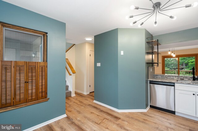 9441 Clocktower Ln, Columbia, MD 21046 - kitchen featuring dishwasher, a chandelier, light wood-style floors, white cabinetry, and baseboards