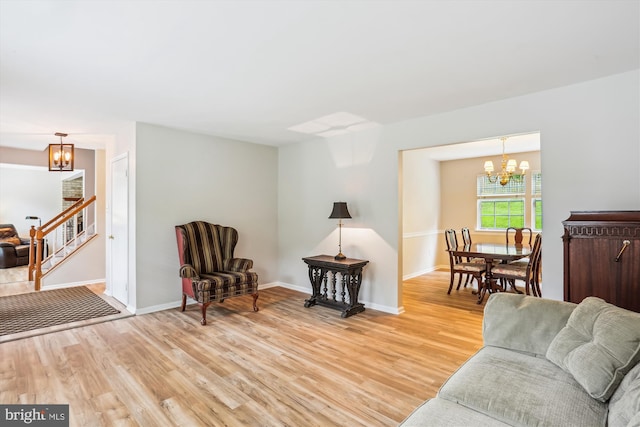 922 Pheasant Run Dr, Gaithersburg, MD 20878 - living room featuring a chandelier, light wood finished floors, stairs, and baseboards
