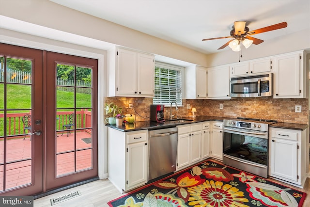 922 Pheasant Run Dr, Gaithersburg, MD 20878 - kitchen with stainless steel appliances, plenty of natural light, a sink, and white cabinets