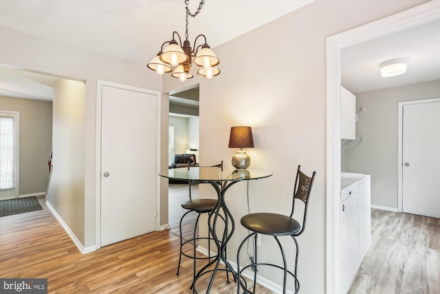 922 Pheasant Run Dr, Gaithersburg, MD 20878 - dining area with light wood finished floors, a chandelier, and baseboards