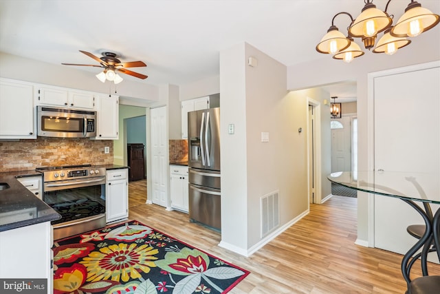 922 Pheasant Run Dr, Gaithersburg, MD 20878 - kitchen featuring stainless steel appliances, white cabinets, a chandelier, and decorative backsplash