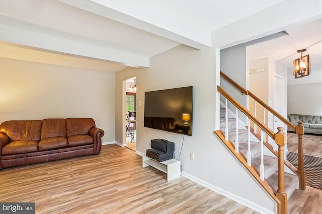 922 Pheasant Run Dr, Gaithersburg, MD 20878 - living area with light wood-style flooring, stairs, baseboards, and a chandelier