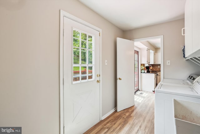 922 Pheasant Run Dr, Gaithersburg, MD 20878 - washroom featuring cabinet space, washing machine and clothes dryer, light wood-style floors, and baseboards
