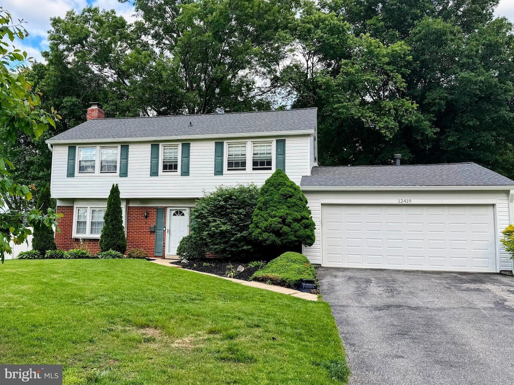 12419 Melling Ln, Bowie, MD 20715 - colonial home with a chimney, driveway, a front lawn, a garage, and brick siding