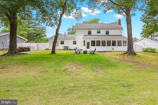 12419 Melling Ln, Bowie, MD 20715 - rear view of property with a sunroom, a chimney, central air condition unit, and an outdoor fire pit