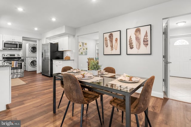 12419 Melling Ln, Bowie, MD 20715 - dining space with estacked washer and dryer, dark wood-type flooring, recessed lighting, and baseboards