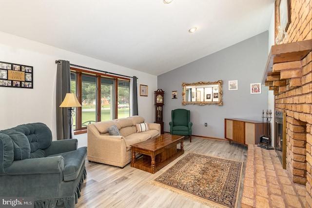 1199 Long Valley Rd, Westminster, MD 21158 - living room featuring lofted ceiling, light wood finished floors, and a brick fireplace