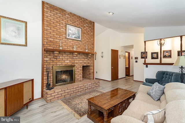 1199 Long Valley Rd, Westminster, MD 21158 - living area featuring lofted ceiling, light wood-style floors, a brick fireplace, and baseboards