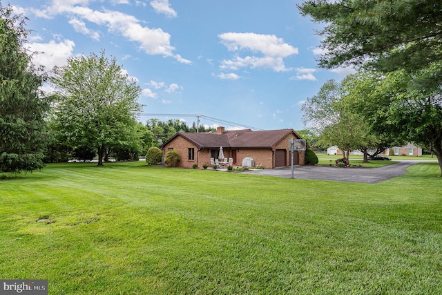 1199 Long Valley Rd, Westminster, MD 21158 - rear view of house featuring brick siding, driveway, an attached garage, a lawn, and a chimney