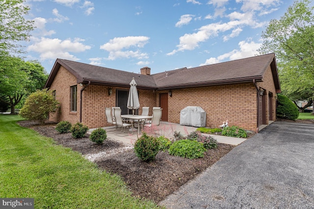 1199 Long Valley Rd, Westminster, MD 21158 - back of house with brick siding, a chimney, a patio area, and a lawn