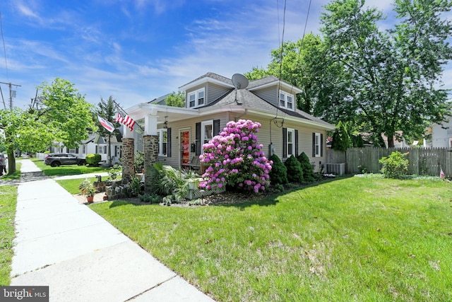 14 E Johnson Ave, Somers Point, NJ 08244 - view of front of home featuring a ceiling fan, covered porch, roof with shingles, and central AC unit