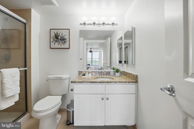 11800 Sunset Hills Rd Unit 717, Reston, VA 20190 - bathroom featuring vanity, toilet, a stall shower, and tile patterned flooring