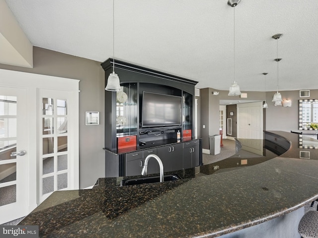 11800 Sunset Hills Rd Unit 717, Reston, VA 20190 - kitchen with a sink, decorative light fixtures, and dark stone counters