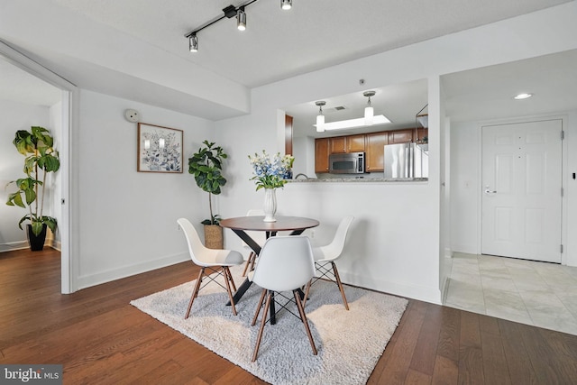11800 Sunset Hills Rd Unit 717, Reston, VA 20190 - dining room with baseboards and light wood finished floors