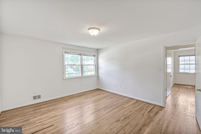 12403 Sir Lancelot Dr, Glenn Dale, MD 20769 - spare room with healthy amount of natural light, light wood-style floors, and baseboards