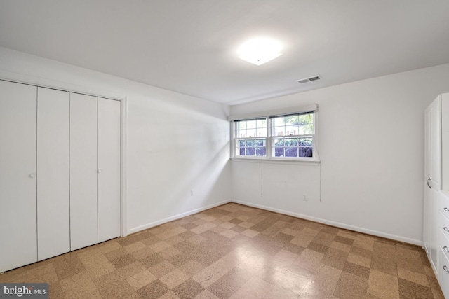 12403 Sir Lancelot Dr, Glenn Dale, MD 20769 - unfurnished bedroom with baseboards, a closet, and tile patterned floors