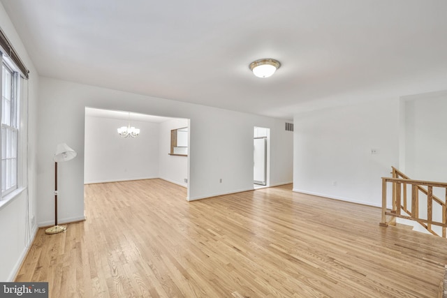 12403 Sir Lancelot Dr, Glenn Dale, MD 20769 - unfurnished room featuring a chandelier, light wood finished floors, and baseboards