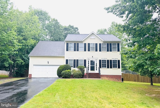 609 Wright Dr, Ruther Glen, VA 22546 - colonial inspired home with driveway, an attached garage, and entry steps