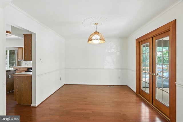 8225 Bubbling Spg, Laurel, MD 20723 - unfurnished dining area with french doors, ornamental molding, and dark wood-style floors