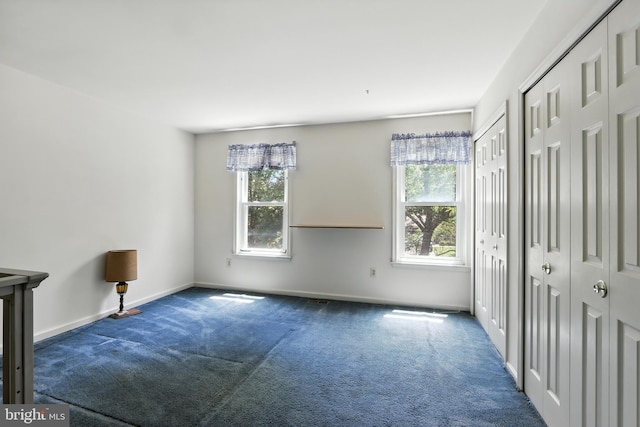 8225 Bubbling Spg, Laurel, MD 20723 - unfurnished bedroom with multiple closets, carpet flooring, and multiple windows