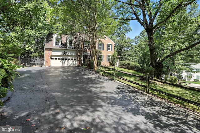 8225 Bubbling Spg, Laurel, MD 20723 - view of front of property with asphalt driveway, an attached garage, and brick siding