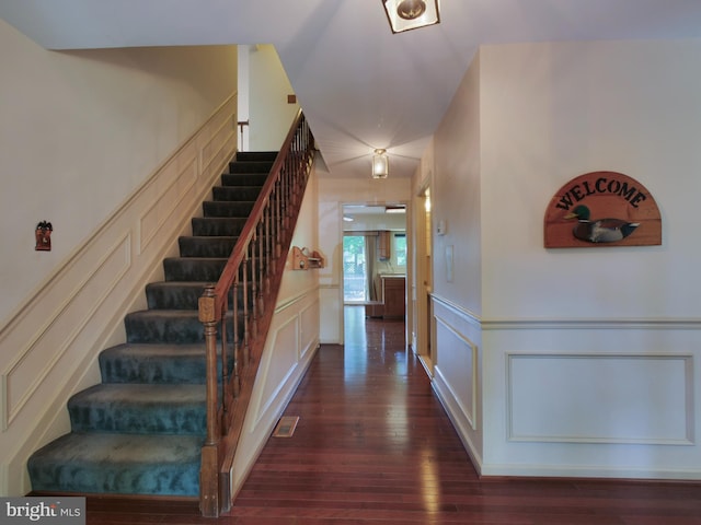 8225 Bubbling Spg, Laurel, MD 20723 - staircase with a decorative wall, hardwood / wood-style flooring, and wainscoting
