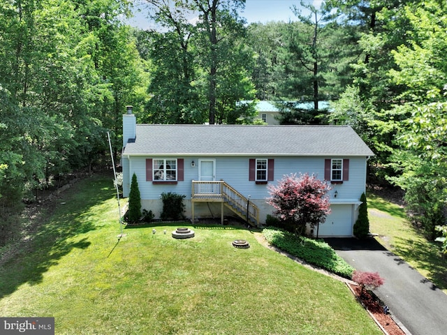 95 Comanche Dr, Auburn, PA 17922 - single story home featuring a garage, asphalt driveway, a chimney, and a front lawn